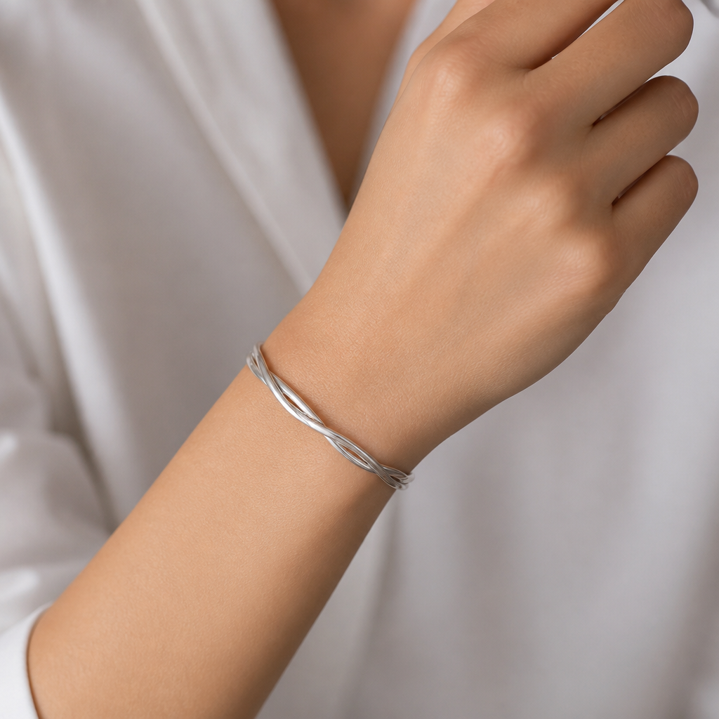 A women's bracelet made of silver, minimalist, simple and delicate, clean lines. 3 1.5mm wires twisted bracelet on hand
photorealistic jewelry design, A women's bracelet made of silver, minimalist, simple and delicate, clean lines. 3 1.5mm wires twisted bracelet on hand, modern style, just the design no text