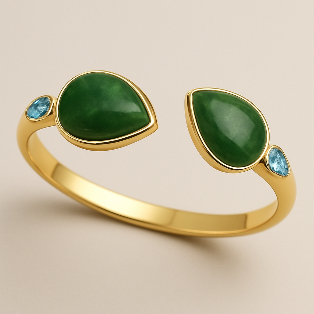 Create a yellow gold cuff with two pear shaped pieces of nephrite jade at the ends and two petite pear shaped blue topaz’s set in the gold of the bracelet