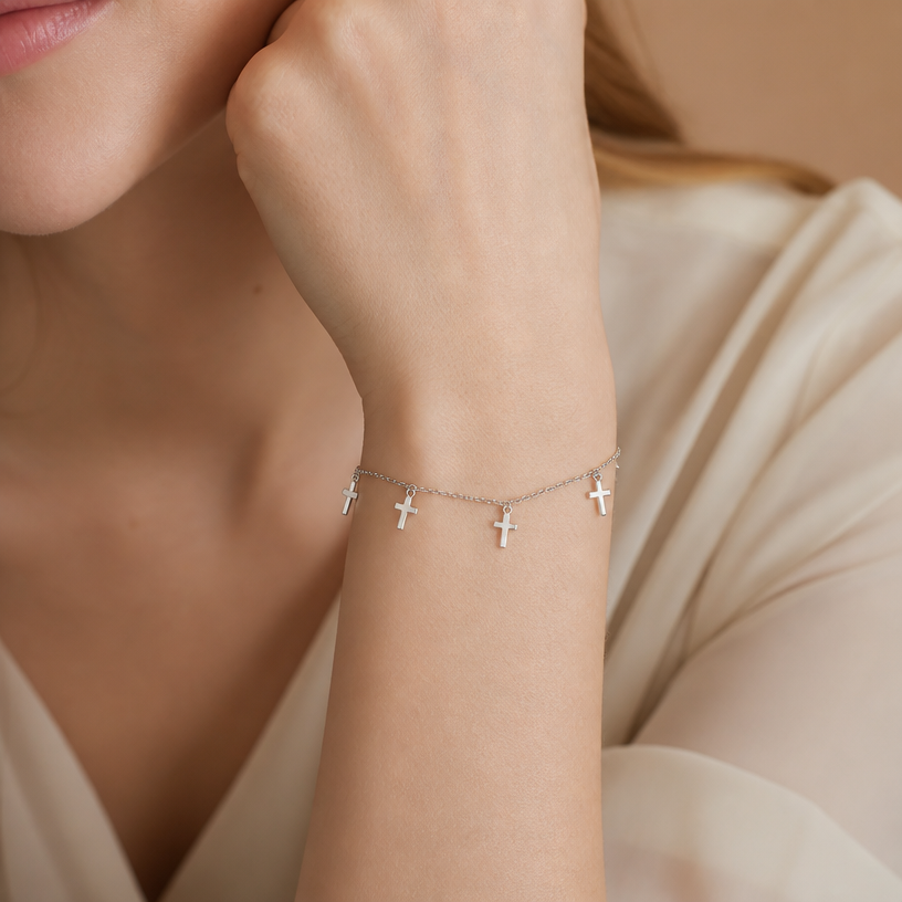 Jewelry photoshoot (worn)
Show the jewelry piece from the image worn by an elegant model in a professional editorial photograph, soft studio lighting. Reproduce the jewelry's exact design, metal, stones and details faithfully. Photorealistic, no text. Additional instructions: "Close-up beauty/editorial photo of a woman's wrist and hand, fair light skin tone, gently relaxed pose (resting on a soft surface or lightly touching her face/collarbone). Soft, warm neutral studio background (beige/cream tones), softly blurred, shallow depth of field.
She wears a delicate sterling silver chain bracelet featuring a small round bezel-set cubic zirconia stone on one side of the chain and a small sideways cross charm on the other side, connected by a fine cable chain.
METAL FINISH: the sterling silver must be rhodium-plated — bright, cool-white, and reflective with a polished mirror-like shine, not dull or matte. The metal should catch light naturally and sparkle realistically, without looking overly glossy, plastic, or artificially glowing.
SKIN REALISM REQUIREMENT: skin must look completely natural and photorealistic — fair, light skin tone to enhance the contrast and shine of the silver, with visible fine skin texture, natural pores, subtle imperfections. Avoid any smooth, plastic, airbrushed, CGI, or overly retouched look. Lighting soft and warm, casting natural gentle shadows.
STRICT SIZE REQUIREMENT: the bracelet must stay true to real-life scale, fine and delicate — the round stone approximately 0.6cm, the cross charm small and slim, both proportionate to the wrist. Do not enlarge or oversize.
BRACELET POSITION: the chain drapes naturally around the wrist, with the round stone and cross charm both visible and facing forward, sitting flat against the skin.
Close-up beauty/editorial photo of a woman's wrist and hand, fair light skin tone, gently relaxed pose (resting on a soft surface or lightly touching her face/collarbone). Soft, warm neutral studio background (beige/cream tones), softly blurred, shallow depth of field.
She wears a delicate sterling silver double-chain bracelet featuring a small infinity symbol charm, partially lined with sparkling pavé cubic zirconia stones on one side, connected by two fine parallel cable chains.
METAL FINISH: the sterling silver must be rhodium-plated — bright, cool-white, and reflective with a polished mirror-like shine, not dull or matte. The metal should catch light naturally and sparkle realistically, without looking overly glossy, plastic, or artificially glowing.
SKIN REALISM REQUIREMENT: skin must look completely natural and photorealistic — fair, light skin tone to enhance the contrast and shine of the silver, with visible fine skin texture, natural pores, subtle imperfections. Avoid any smooth, plastic, airbrushed, CGI, or overly retouched look. Lighting soft and warm, casting natural gentle shadows.
STRICT SIZE REQUIREMENT: the bracelet must stay true to real-life scale, fine and delicate — the infinity charm small and slim, proportionate to the wrist, double chain thin and dainty. Do not enlarge or oversize.
BRACELET POSITION: the double chain drapes naturally around the wrist, with the infinity charm centered and facing forward, sitting flat against the skin.
"Close-up beauty/editorial photo of a woman's wrist and hand, fair light skin tone, gently relaxed pose (resting on a soft surface or lightly touching her face/collarbone). Soft, warm neutral studio background (beige/cream tones), softly blurred, shallow depth of field.
She wears a delicate sterling silver chain bracelet featuring four small round bezel-set cubic zirconia stones evenly spaced along a fine cable chain.
METAL FINISH: the sterling silver must be rhodium-plated — bright, cool-white, and reflective with a polished mirror-like shine, not dull or matte. The metal should catch light naturally and sparkle realistically, without looking overly glossy, plastic, or artificially glowing.
SKIN REALISM REQUIREMENT: skin must look completely natural and photorealistic — fair, light skin tone to enhance the contrast and shine of the silver, with visible fine skin texture, natural pores, subtle imperfections. Avoid any smooth, plastic, airbrushed, CGI, or overly retouched look. Lighting soft and warm, casting natural gentle shadows.
STRICT SIZE REQUIREMENT: the bracelet must stay true to real-life scale, fine and delicate — each round stone approximately 0.5cm, evenly spaced along the thin chain, proportionate to the wrist. Do not enlarge or oversize.
BRACELET POSITION: the chain drapes naturally around the wrist, with all four stones visible and evenly spaced, sitting flat against the skin, catching soft light.
Close-up beauty/editorial photo of a woman's wrist and hand, fair light skin tone, gently relaxed pose (resting on a soft surface or lightly touching her face/collarbone). Soft, warm neutral studio background (beige/cream tones), softly blurred, shallow depth of field.
She wears a delicate sterling silver chain bracelet featuring four small plain polished cross charms dangling evenly along a fine cable chain.
METAL FINISH: the sterling silver must be rhodium-plated — bright, cool-white, and reflective with a polished mirror-like shine, not dull or matte. The metal should catch light naturally and sparkle realistically, without looking overly glossy, plastic, or artificially glowing.
SKIN REALISM REQUIREMENT: skin must look completely natural and photorealistic — fair, light skin tone to enhance the contrast and shine of the silver, with visible fine skin texture, natural pores, subtle imperfections. Avoid any smooth, plastic, airbrushed, CGI, or overly retouched look. Lighting soft and warm, casting natural gentle shadows.
STRICT SIZE REQUIREMENT: the bracelet must stay true to real-life scale, fine and delicate — each cross charm approximately 0.7cm height x 0.5cm width, dangling evenly along the thin chain, proportionate to the wrist. Do not enlarge or oversize.
BRACELET POSITION: the chain drapes naturally around the wrist, with all four cross charms visible and gently dangling, sitting naturally against the skin, catching soft light.
Mood: elegant, minimal, intimate — high-end jewelry brand photography style, sharp focus on the bracelet while keeping the composition natural and soft..