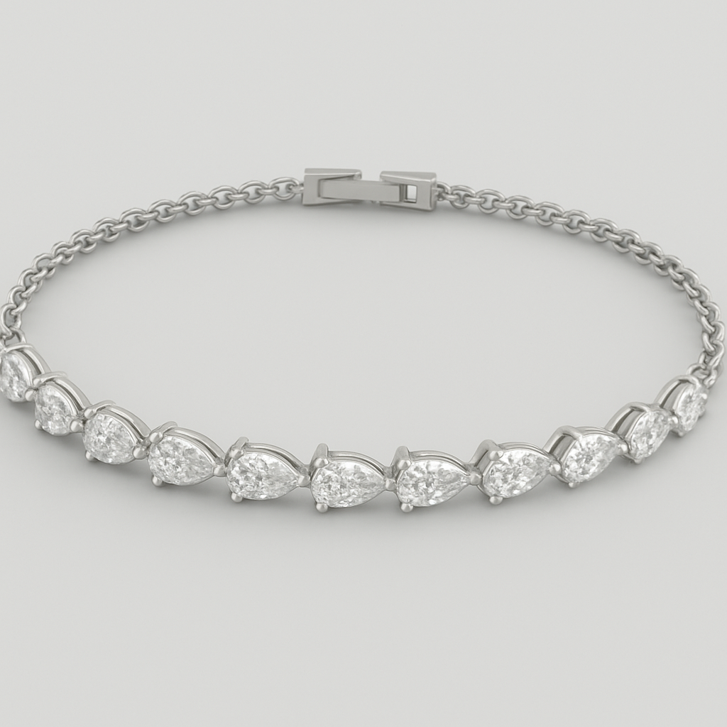 CAD model of a delicate tennis bracelet with pear-shaped diamonds laying on their sides, all pointing left. Each teardrop diamond is set horizontally along a thin white gold chain, forming a smooth continuous flow. Small elegant proportions, precise prong settings, evenly spaced stones, realistic curvature around the wrist. Designed for fine jewelry production.”