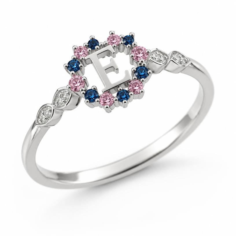 A minimalist women's ring, detailed and decorative, moderately ornate. um anel de 15 anos com inicial E com pedrinhas azul e pedrinhas rosa em volta
using the attached image as a visual reference, create A minimalist women's ring, detailed and decorative, moderately ornate. um anel de 15 anos com inicial E com pedrinhas azul e pedrinhas rosa em volta. photorealistic, just the design no text