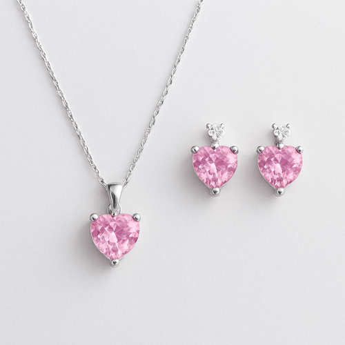 This elegant jewellery set features heart-shaped pink gemstones as the focal point, symbolizing romance and grace.
Delicate silver chains with small round white stones add sparkle and movement.
The matching necklace and earrings create a balanced, modern yet feminine look.
Perfect for romantic occasions, it embodies soft luxury and timeless charm.