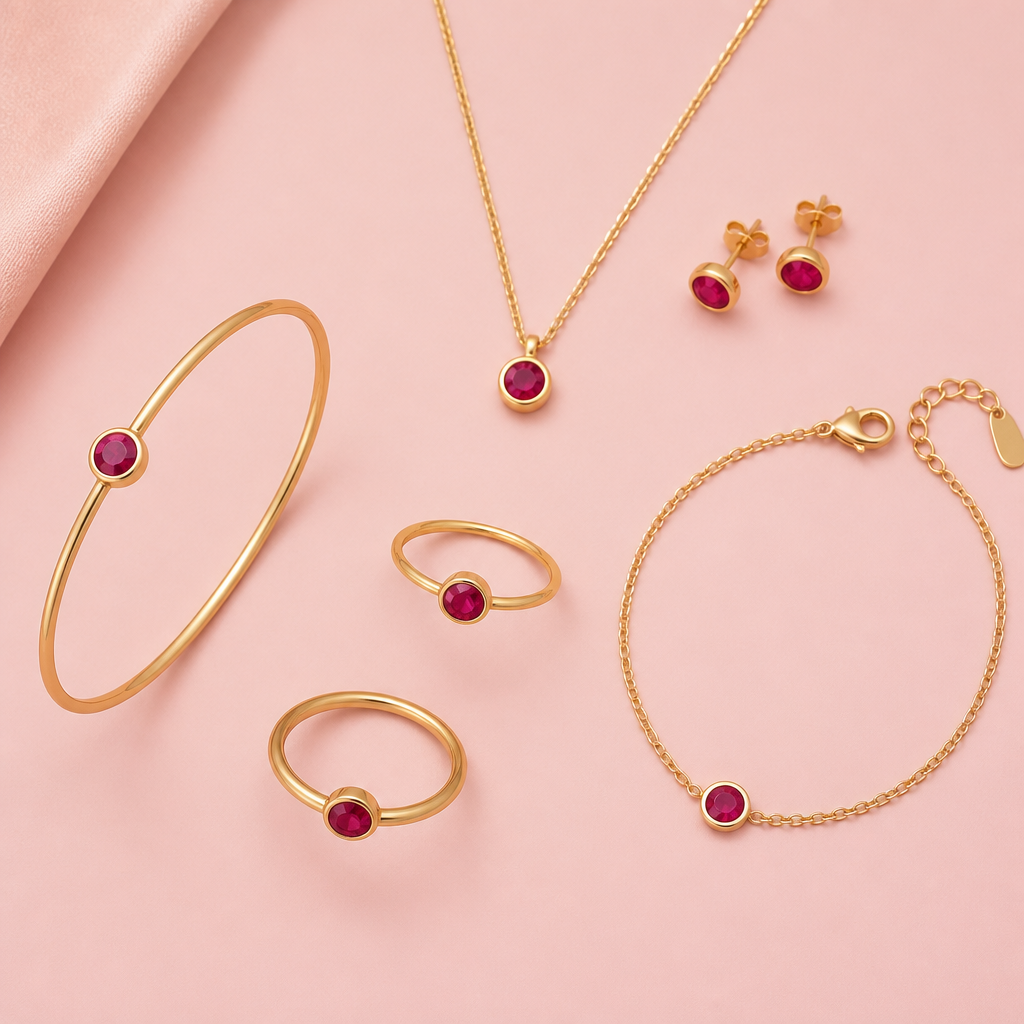 Multiple pieces of Ruby Jewelry including rings, pendants, earrings, bracelets, etc with a blush pink background
Minimalist jewelry: Minimalist ruby jewelry set. Simple gold rings, pendants, earrings, and bracelets with small, round rubies. Blush pink background.