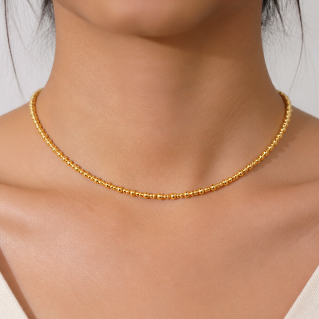 A women's necklace made of gold. 1mm golden beads and 0mm golden beads single thushi design