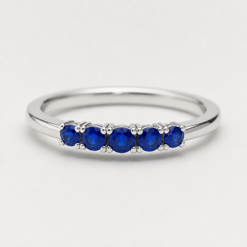 A minimalist women's ring made of silver with sapphire stones
using the attached image as a visual reference, create A minimalist women's ring made of silver with sapphire stones. photorealistic, just the design no text