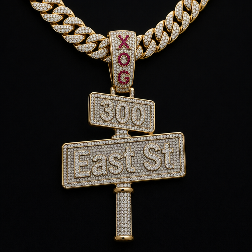 make a diamond pendent of a street sign the bottom sign say East St with a pole coming out the bottom and the top sign say 300 and put it on a cuban link chain and on the bail connecting the pendent to the chain make it say XOG with red rubys
edit the attached jewelry design with these instructions: make a diamond pendent of a street sign the bottom sign say East St with a pole coming out the bottom and the top sign say 300 and put it on a cuban link chain and on the bail connecting the pendent to the chain make it say XOG with red rubys. keep it photorealistic, just the design no text