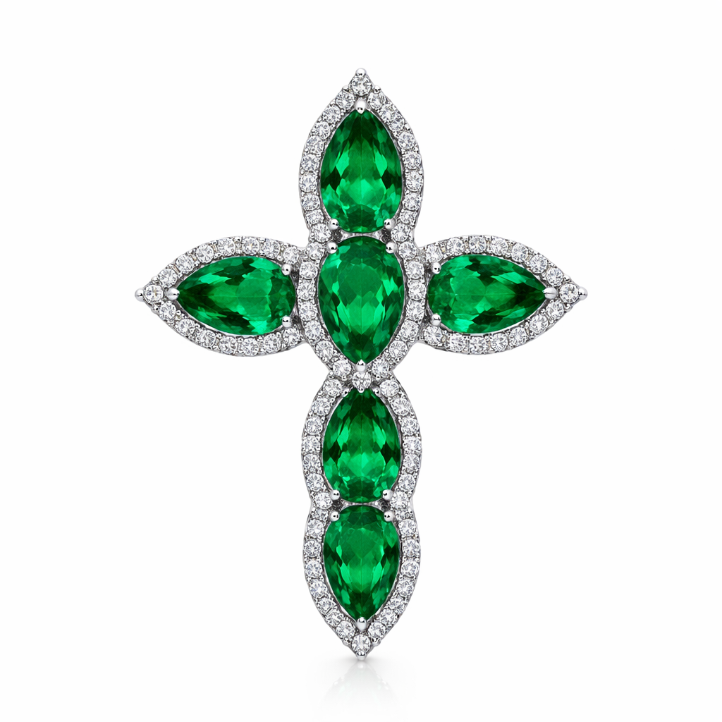 Pear cut emerald cross on 14k white gold with bale attached to the back and not shown. Few diamond accent stones